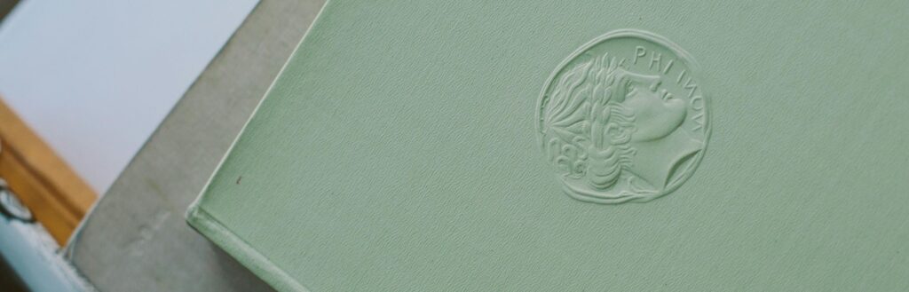 A tactile view of a book cover featuring raised graphic elements and textured patterns.