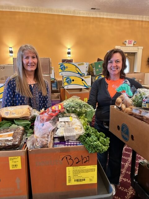 Lakeside Book Company team members Mary Hatch and Linda Page collaborating on a community project.