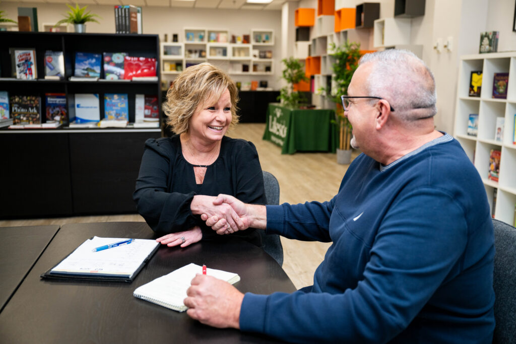 Candid photo of Lakeside Book Company advisors discussing supply chain strategy with a client.