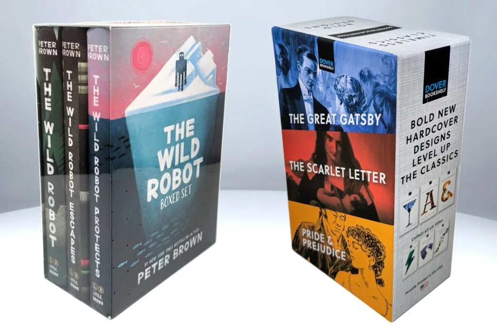 A collection of hardcover books including 'The Wild Robot' series by Peter Brown and classic editions of 'The Great Gatsby' and 'The Scarlet Letter'