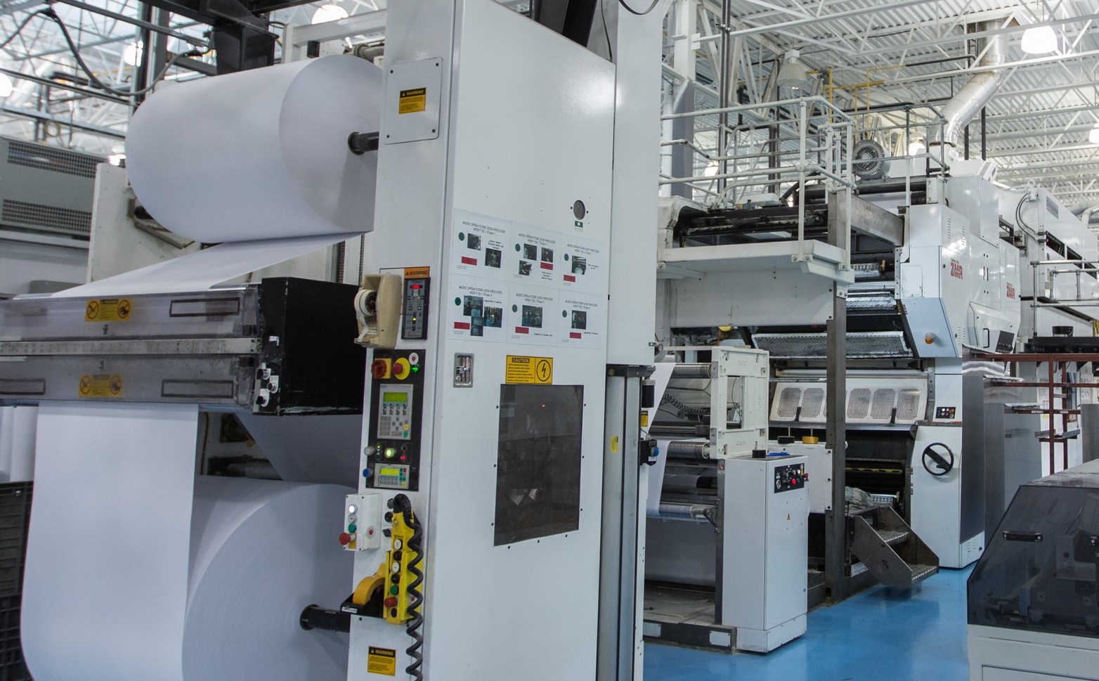 Industrial high-speed offset printing press at Lakeside Book Company manufacturing facility.